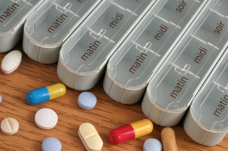 A view of a daily pill box surrounded by different tablets