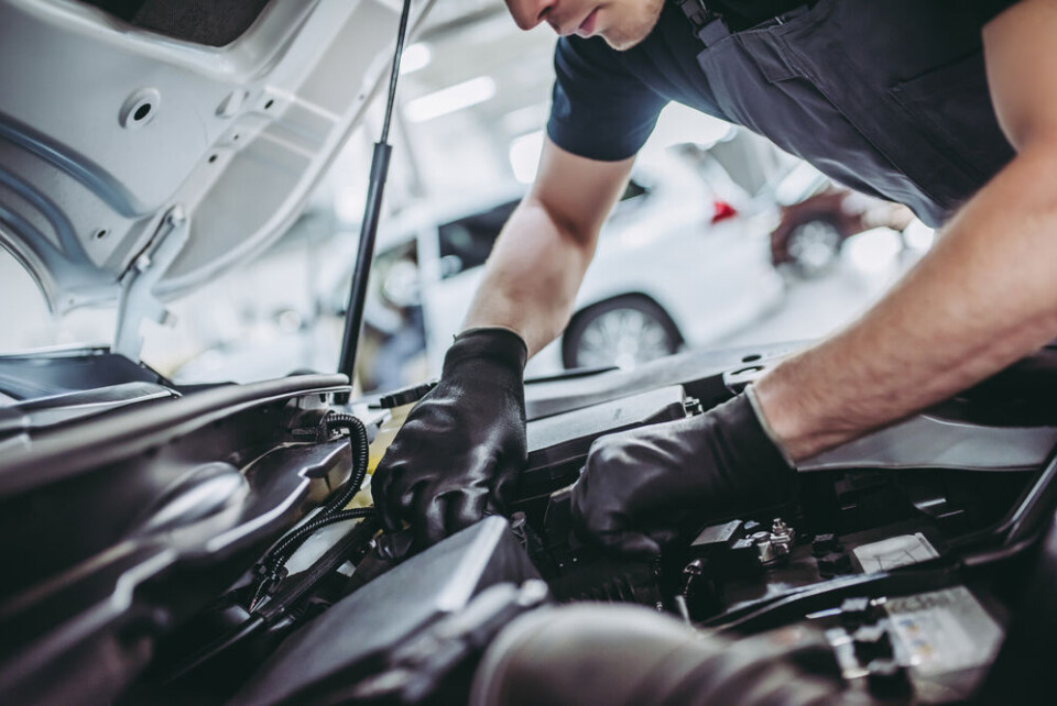 A view of a mechanic fixing a car engine