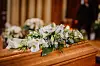 A coffin with flowers laid on top during a funeral in France.