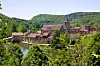 A view of Marcilhac-sur-Célé in a valley in Occitania, with water in front