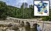 Medieval long bridge over a river showing low water level, inset map of water tables in France for April 2024