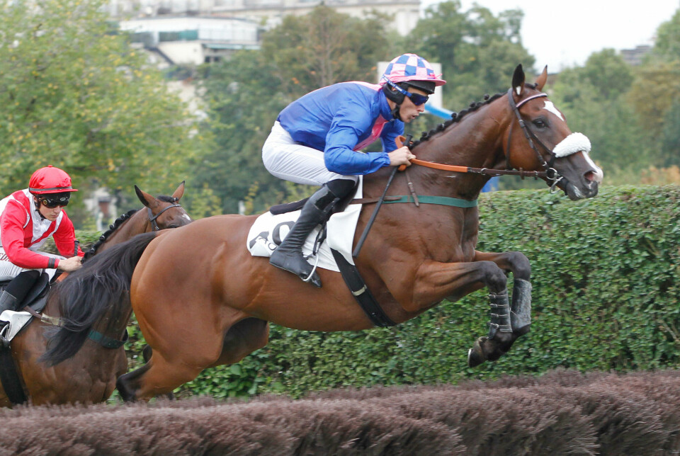 A view of James Reveley riding a horse during a race at Auteuil, Paris, 2016