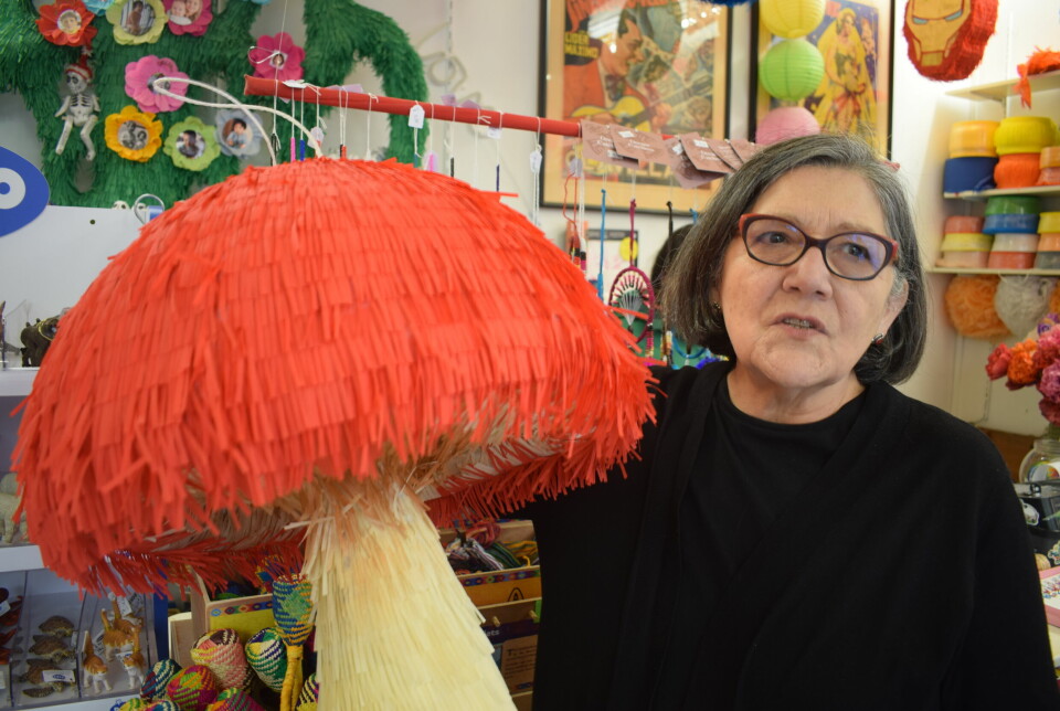 Elena Farah next to a piñata in the shape of a mushroom