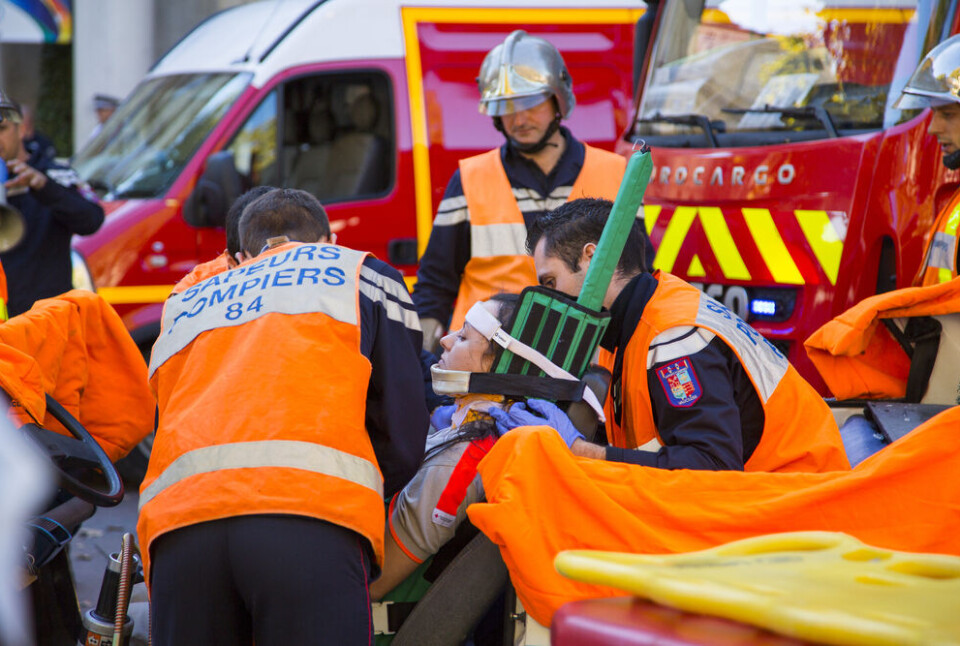 Kemal Taner/Shutterstock Lady on stretcher receives emergency care from French paramedics