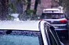 Heavy rain falling on a car roof