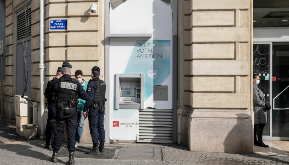 French police in Marseille do an identity check on a young person wearing a face mask