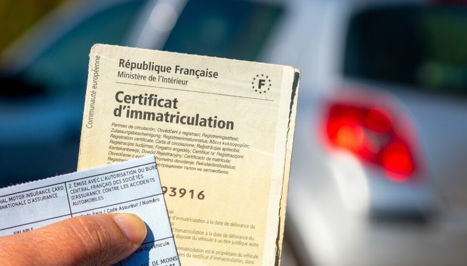 French carte grise vehicle identification paper with car in background