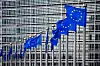 A line of EU flags in front of the European Commission in Brussels