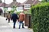 People walk to polling station in residential area in UK