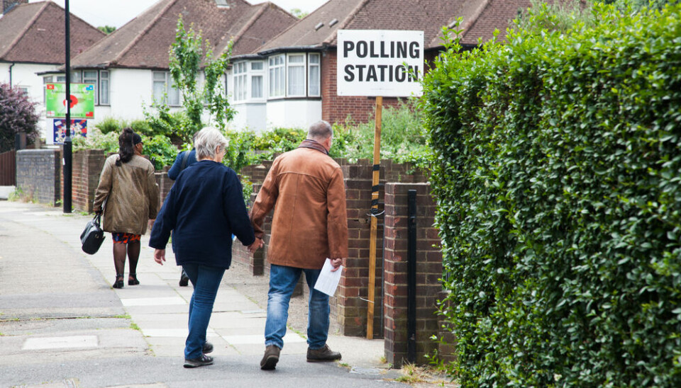 People walk to polling station in residential area in UK