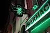 Outside of french pharmacy lit up at night - on-duty pharmacies remain open during strikes