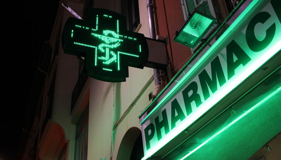 Outside of french pharmacy lit up at night - on-duty pharmacies remain open during strikes