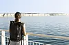 Woman on a ferry looking at white cliffs of Dover