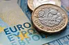 Pound sterling coins on european notes symbolising the pound to euro exchange rate that slipped following the french european election results