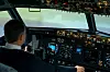 A man simulated flying a plane in a French flight simulator
