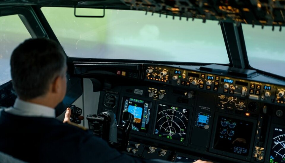 A man simulated flying a plane in a French flight simulator