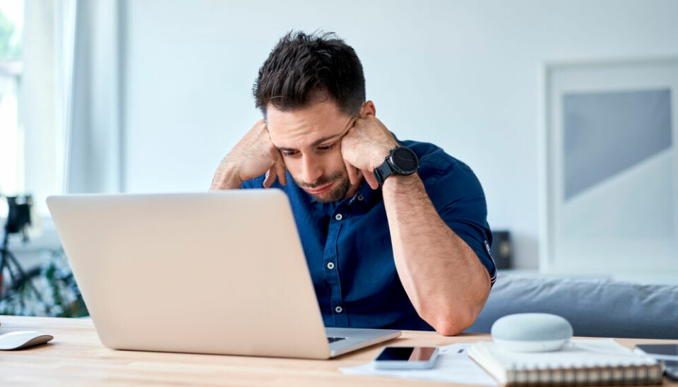 Man frustrated looking at laptop