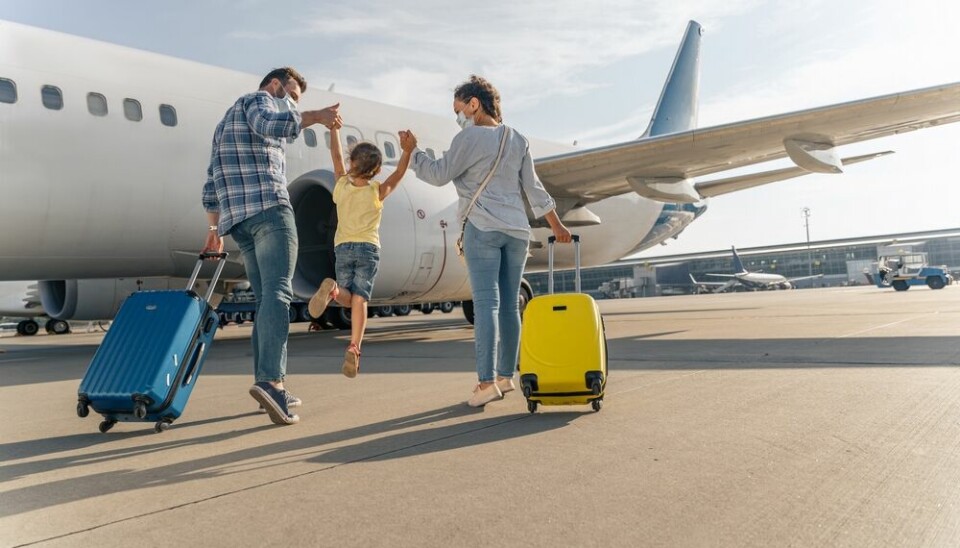 Family with luggage approach plane