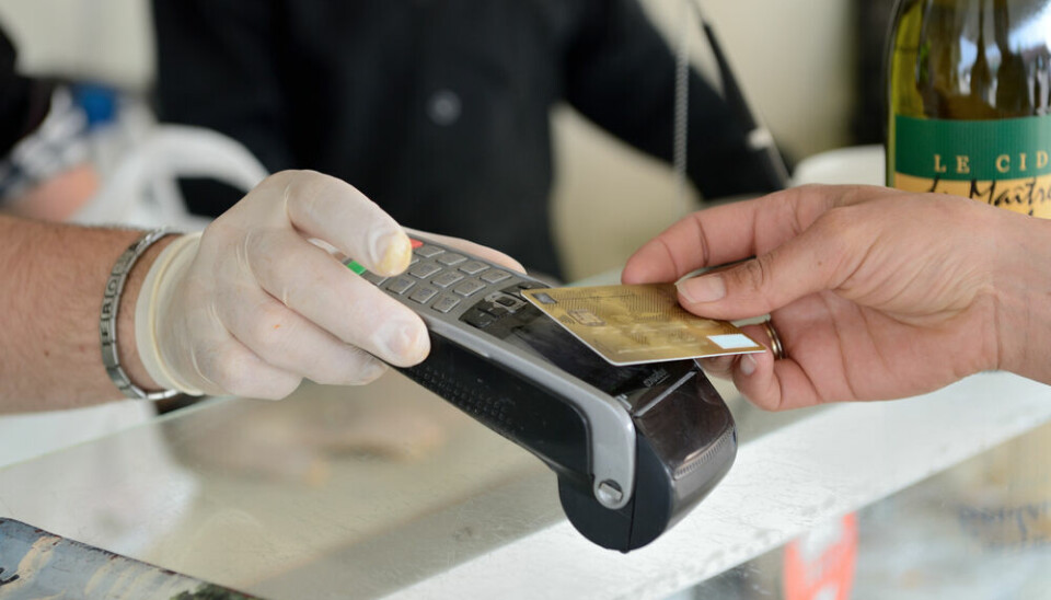 A view of someone using contactless payment on a card machine in Normandy, France