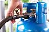 Person hooking up a gas canister