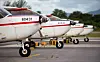 Cessna light aircrafts lined up at an airport