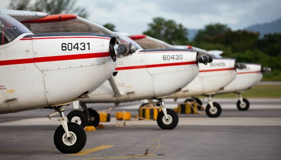 Cessna light aircrafts lined up at an airport