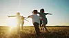 Children running at sunset