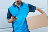A man - looking at a phone - trying to deliver a parcel