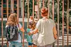 Children with parent outside a school gate