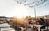 A group of friends on a balcony drinking together