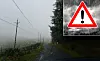 Heavy rain on a road in the Cévennes with inset weather warning