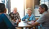 A view of elderly people having coffee together