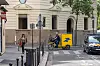 A pedal-powered La Poste delivery vehicle on the streets