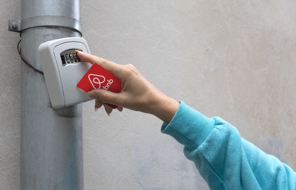 AlenKadr/Shutterstock A view of someone using a lock box attached to a drain pipe for their Airbnb