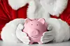 A view of a Father Christmas holding a piggy bank