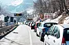 Many cars waiting in a row to go trough the Col de Tende Road Tunnel, Colle di Tenda. The tunnel that unites Italy with France. Italy, Cuneo