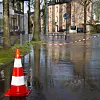 Traffic cone sits in flooded street