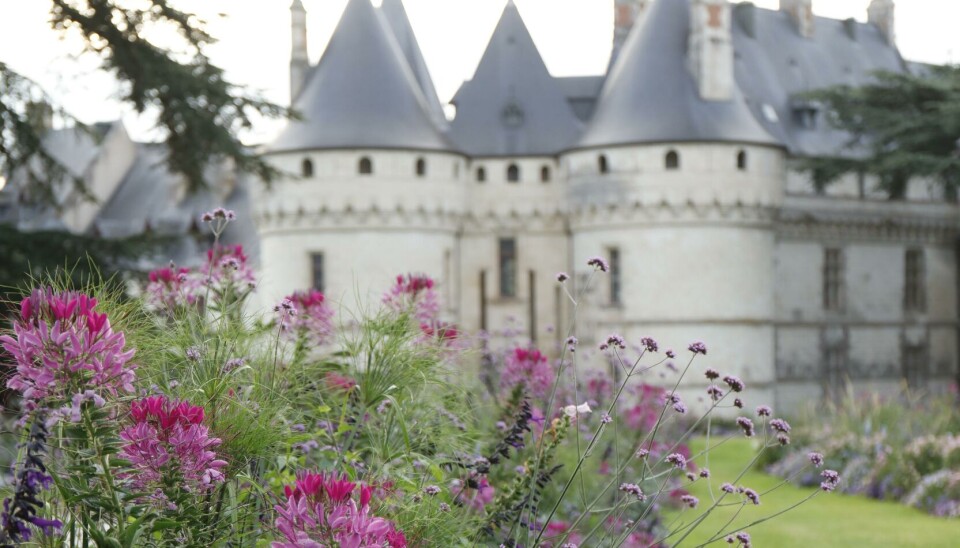 Eric Sander A French castle sits behind a lush lawn and flowerbed