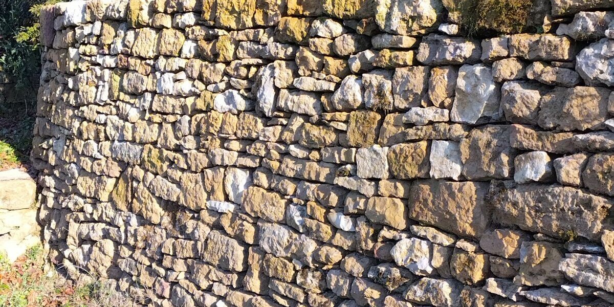 Repairs on dry stone wall in france: must stones be bought or can they be picked up?