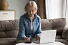 Mature woman with her laptop and calculator