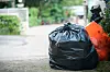 A view of a black bin bag outside a house