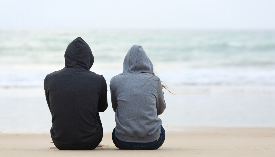 Antonio Guillem/Shutterstock Back view of two sad teenagers in hoodies looking out to sea