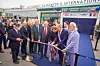 Officials cut a ribbon outside the airport