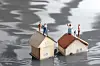 A view of some model houses surrounded by water to show flooding