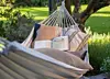 Cotton hammock hanging in a garden
