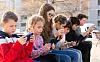 Kids,Using,Phones,Outdoors,,Concept,Of,Children,Addiction,To,Social