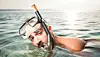 A man wearing snorkeling gear in the sea