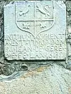 A stone plaque showing a coat of arms
