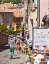 A narrow street with shops in a French village