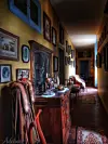 Grand chateau interior. A corridor with chairs, rugs and frames